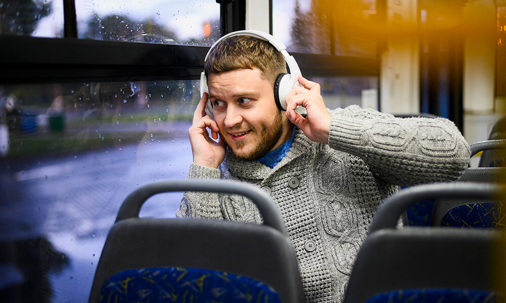 man with headphones in bus