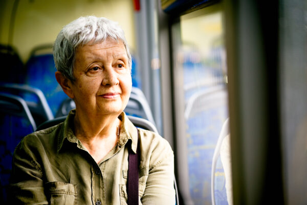 Senior woman traveling by bus